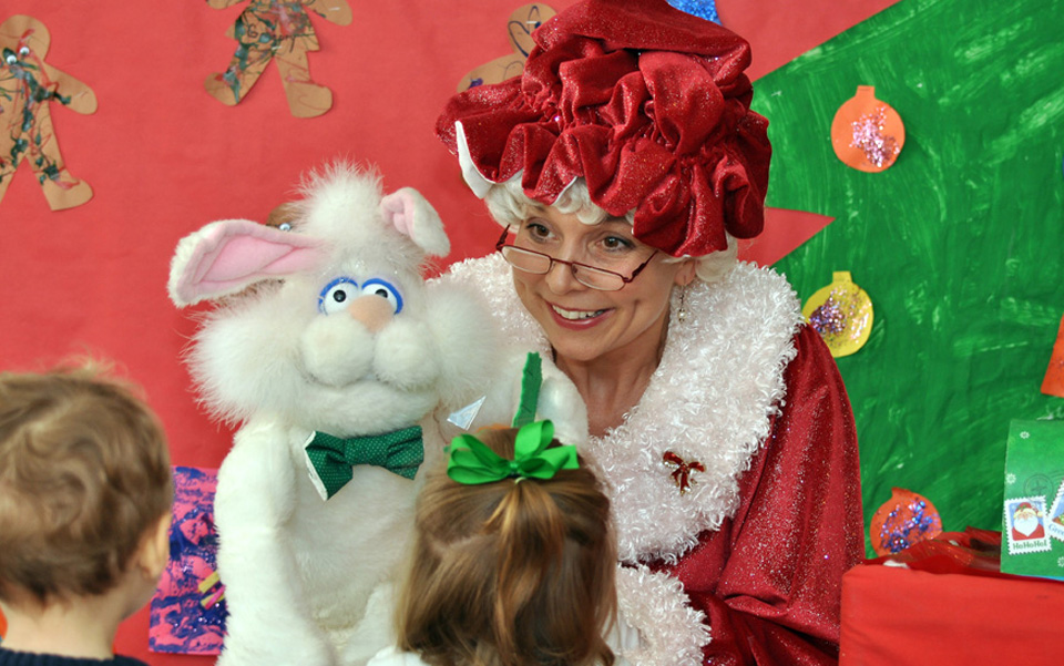 Mrs. Santa with Christmas bunny puppet.